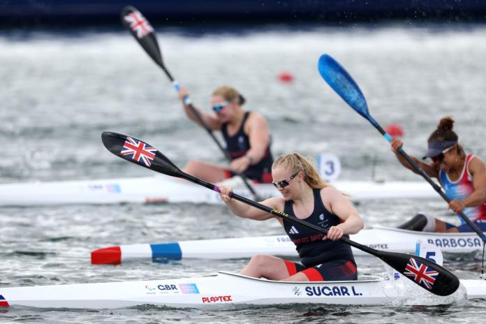 Three Para canoe athletes are in action